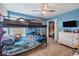 Cozy bedroom with bunk beds, a large window, closet and blue walls at 16833 Terrapin Key Dr, Port Charlotte, FL 33953