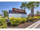 The Hammocks community sign is a decorative entrance and features beautiful tropical landscaping at 16833 Terrapin Key Dr, Port Charlotte, FL 33953