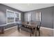 Elegant dining room featuring a modern table with bench seating, complemented by stylish decor and natural light at 16833 Terrapin Key Dr, Port Charlotte, FL 33953