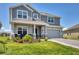 Charming two-story home with a well-manicured lawn, a covered porch, and an attached two-car garage at 16833 Terrapin Key Dr, Port Charlotte, FL 33953