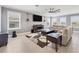 Bright and airy living room with modern furnishings, tile floors, and a large sectional sofa at 16833 Terrapin Key Dr, Port Charlotte, FL 33953