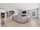 Bright and spacious living room with a modern ceiling fan, and view of the stairs to the second floor at 16833 Terrapin Key Dr, Port Charlotte, FL 33953