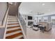 Bright and spacious living room featuring tile floors, a modern ceiling fan, and stairs to the second floor at 16833 Terrapin Key Dr, Port Charlotte, FL 33953