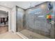 Modern shower with sleek tile, glass enclosure, and convenient built-in shelving at 16833 Terrapin Key Dr, Port Charlotte, FL 33953