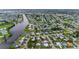 Expansive aerial view of waterfront homes, canals, and lush greenery in an attractive residential neighborhood at 180 Palmetto Ne Cir, Port Charlotte, FL 33952
