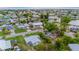 Aerial view of a residential area with waterfront properties and canals amidst lush greenery and nearby homes at 180 Palmetto Ne Cir, Port Charlotte, FL 33952