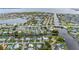 Expansive aerial view of homes along canals and waterfront properties with a bridge and nearby bay at 180 Palmetto Ne Cir, Port Charlotte, FL 33952