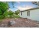 The backyard has a few trees at 180 Palmetto Ne Cir, Port Charlotte, FL 33952