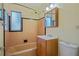 Traditional bathroom featuring a tub, vanity, medicine cabinet, and tiled walls at 180 Palmetto Ne Cir, Port Charlotte, FL 33952