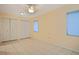 Bedroom with ample storage, tile flooring, fan, and natural light at 180 Palmetto Ne Cir, Port Charlotte, FL 33952
