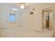 Bedroom with tile flooring, fan, closet and an adjacent bathroom at 180 Palmetto Ne Cir, Port Charlotte, FL 33952