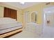 Bedroom featuring a daybed, dresser, tile floors, and closet space at 180 Palmetto Ne Cir, Port Charlotte, FL 33952