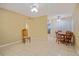 Dining area features tile flooring and ceiling fan at 180 Palmetto Ne Cir, Port Charlotte, FL 33952