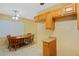 Cozy kitchen with wooden cabinets and a dining area with a wooden table and chairs at 180 Palmetto Ne Cir, Port Charlotte, FL 33952