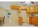 Open kitchen featuring wooden cabinets and views to the dining area at 180 Palmetto Ne Cir, Port Charlotte, FL 33952