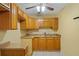 Functional kitchen with wooden cabinets, sink, and countertop space at 180 Palmetto Ne Cir, Port Charlotte, FL 33952