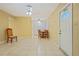 Open floor plan living room and dining area with tile flooring and ceiling fans at 180 Palmetto Ne Cir, Port Charlotte, FL 33952