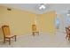 Open floor plan living room with tile flooring and ceiling fan at 180 Palmetto Ne Cir, Port Charlotte, FL 33952