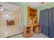 Room with a desk, star patterned curtains and view into the hall at 180 Palmetto Ne Cir, Port Charlotte, FL 33952