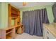 Desk, star patterned curtains and view of the cabinet in a room at 180 Palmetto Ne Cir, Port Charlotte, FL 33952