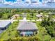 Aerial view of the backyard with pool and surrounding neighborhood at 185 Hercules Dr, Rotonda West, FL 33947