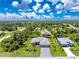 Expansive aerial shot showcases a charming single-Gathering home with a well-manicured lawn and inviting curb appeal at 185 Hercules Dr, Rotonda West, FL 33947