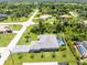 Aerial view of a single Gathering home with a private screened in pool area, and well manicured lawn at 185 Hercules Dr, Rotonda West, FL 33947