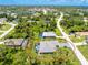 An aerial view of a single-Gathering home with a screened-in pool area and well-maintained landscaping at 185 Hercules Dr, Rotonda West, FL 33947