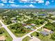This aerial shot showcases a single-Gathering home with a spacious yard and a serene neighborhood setting at 185 Hercules Dr, Rotonda West, FL 33947