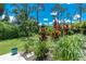 Backyard presents lush landscaping with various tropical plants at 185 Hercules Dr, Rotonda West, FL 33947