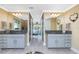 Bathroom featuring dual sink vanity and a view into the connected bedroom at 185 Hercules Dr, Rotonda West, FL 33947