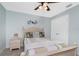 Bedroom featuring an ornate ceiling fan, neutral colored walls, and coordinated bedding at 185 Hercules Dr, Rotonda West, FL 33947