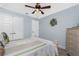 Bedroom featuring an ornate ceiling fan, neutral colored walls, and coordinated bedding at 185 Hercules Dr, Rotonda West, FL 33947