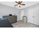 Bedroom offers ceiling fan, tile flooring, closet and two doors at 185 Hercules Dr, Rotonda West, FL 33947