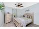 Bedroom featuring an ornate ceiling fan, neutral colored walls, and coordinated bedding at 185 Hercules Dr, Rotonda West, FL 33947
