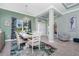 Elegant dining room featuring a chandelier, a decorative rug, and a window with floral curtains at 185 Hercules Dr, Rotonda West, FL 33947