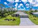 Beautiful single-story home with a well-manicured lawn, mature trees, and a spacious three-car garage at 185 Hercules Dr, Rotonda West, FL 33947