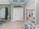 Bright foyer with neutral tile flooring, a front door with sidelights, and an open view to other rooms at 185 Hercules Dr, Rotonda West, FL 33947