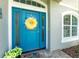 Close up of a bright blue front door and 'welcome home' mat at 185 Hercules Dr, Rotonda West, FL 33947