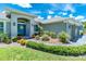 Close-up of a home's entryway, showcasing a vibrant blue front door with stylish details at 185 Hercules Dr, Rotonda West, FL 33947