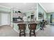 Stylish kitchen featuring a breakfast bar with seating, granite countertops, and modern appliances at 185 Hercules Dr, Rotonda West, FL 33947