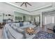 Bright open-concept living space showing the kitchen, a dining area, and a large sectional sofa at 185 Hercules Dr, Rotonda West, FL 33947