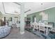 Open living space showcasing dining area, a cozy blue sofa, and stylish decor with tile flooring at 185 Hercules Dr, Rotonda West, FL 33947