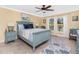 Comfortable bedroom with nautical decor, a ceiling fan, and ample natural light from the large windows at 185 Hercules Dr, Rotonda West, FL 33947