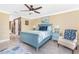 Inviting bedroom with a ceiling fan, soft yellow walls, and access to an adjacent bathroom at 185 Hercules Dr, Rotonda West, FL 33947