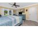 Bright bedroom with neutral tones, a ceiling fan, and an exit to the outdoor pool area at 185 Hercules Dr, Rotonda West, FL 33947