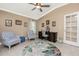 Cozy office featuring a fan, two upholstered chairs, and a writing desk at 185 Hercules Dr, Rotonda West, FL 33947