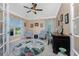 Cozy home office with natural light, French doors, and comfortable seating at 185 Hercules Dr, Rotonda West, FL 33947