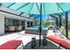 Inviting outdoor patio with swim spa, dining area, and cozy seating, creating a perfect backyard oasis at 185 Hercules Dr, Rotonda West, FL 33947
