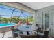 View of the pool and spa area, surrounded by a screened enclosure at 185 Hercules Dr, Rotonda West, FL 33947